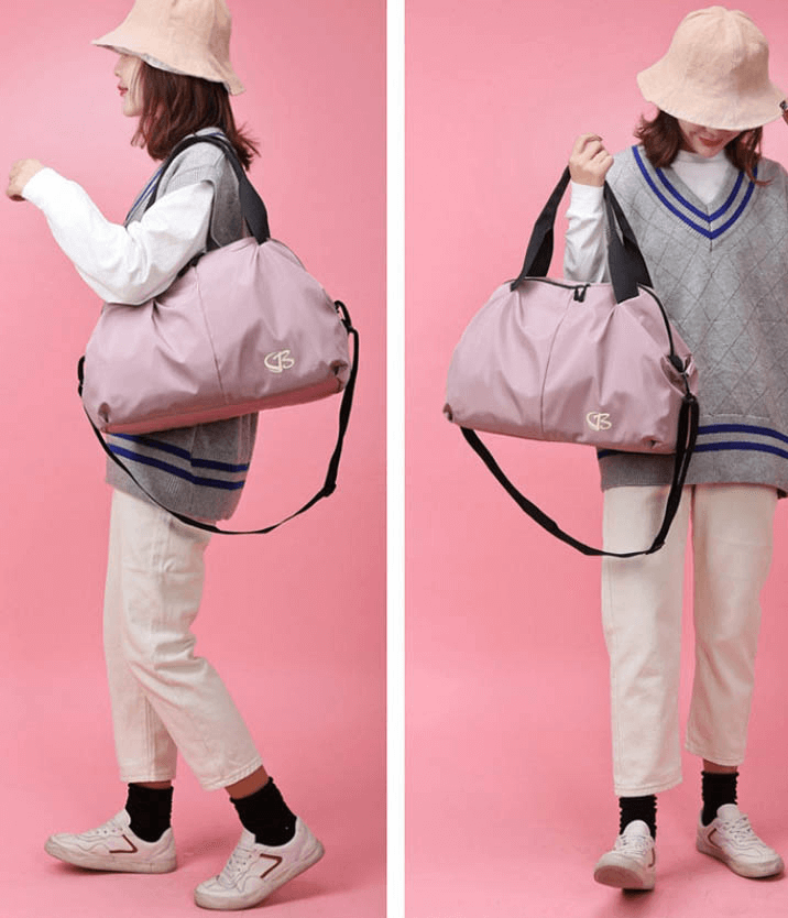 Woman carrying Multifunction Waterproof Women's Large Capacity Gym Bag SF0904, pink color, perfect for sports and travel.
